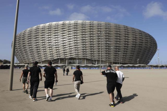 People walk near the new Prince Moulay Abdellah Stadium in Rabat, which was completely demolished in 2023 and rebuilt according to the latest international standards, in Rabat, on September 5, 2025, ahead of the FIFA World Cup 2026 Group E African qualification football match between Morocco and Niger. The stadium built in preparation for two major events: the 2025 Africa Cup of Nations and the 2030 FIFA World Cup, co-hosted by Morocco, Spain, and Portugal. (Photo by Abdel Majid BZIOUAT / AFP)