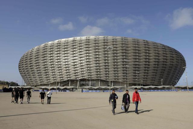People walk near the new Prince Moulay Abdellah Stadium in Rabat, which was completely demolished in 2023 and rebuilt according to the latest international standards, in Rabat, on September 5, 2025, ahead of the FIFA World Cup 2026 Group E African qualification football match between Morocco and Niger. The stadium built in preparation for two major events: the 2025 Africa Cup of Nations and the 2030 FIFA World Cup, co-hosted by Morocco, Spain, and Portugal. (Photo by Abdel Majid BZIOUAT / AFP)