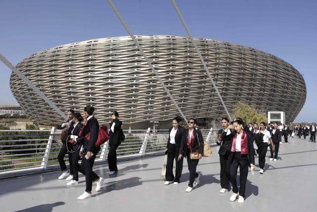 People walk near the new Prince Moulay Abdellah Stadium in Rabat, which was completely demolished in 2023 and rebuilt according to the latest international standards, in Rabat, on September 5, 2025, ahead of the FIFA World Cup 2026 Group E African qualification football match between Morocco and Niger. The stadium built in preparation for two major events: the 2025 Africa Cup of Nations and the 2030 FIFA World Cup, co-hosted by Morocco, Spain, and Portugal. (Photo by Abdel Majid BZIOUAT / AFP)