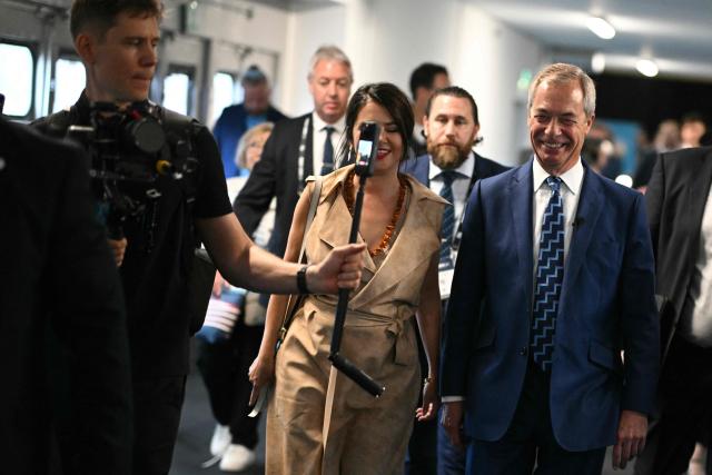 Reform UK leader Nigel Farage (R) arrives with partner French politician Laure Ferrari (C) on the first day of the Reform UK party conference at the NEC Birmingham, central England, on September 5, 2025. Nigel Farage's anti-immigration Reform UK kicks off Britain's annual party conference season on September 5, with the Brexit cheerleader and his buoyant supporters increasingly confident he could be Britain's next leader. (Photo by Oli SCARFF / AFP)