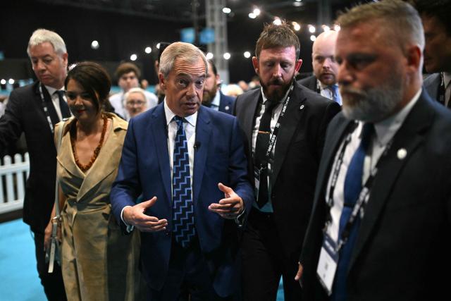 Reform UK leader Nigel Farage (C) arrives with partner French politician Laure Ferrari (CL) on the first day of the Reform UK party conference at the NEC Birmingham, central England, on September 5, 2025. Nigel Farage's anti-immigration Reform UK kicks off Britain's annual party conference season on September 5, with the Brexit cheerleader and his buoyant supporters increasingly confident he could be Britain's next leader. (Photo by Oli SCARFF / AFP)