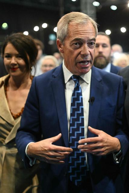 Reform UK leader Nigel Farage (R) arrives with partner French politician Laure Ferrari (L) on the first day of the Reform UK party conference at the NEC Birmingham, central England, on September 5, 2025. Nigel Farage's anti-immigration Reform UK kicks off Britain's annual party conference season on September 5, with the Brexit cheerleader and his buoyant supporters increasingly confident he could be Britain's next leader. (Photo by Oli SCARFF / AFP)