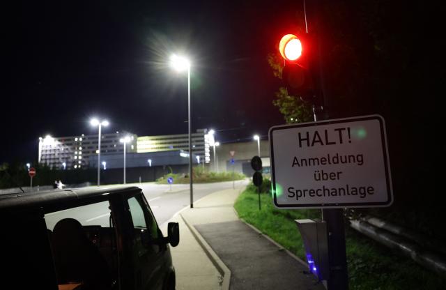 A car stands in front of the women's prison in Chemnitz where trans right-wing extremist Marla-Svenja Liebich was to serve prison time on August 29, 2025. A fierce debate has erupted in Germany around the neo-Nazi who is set to begin a jail term on August 29 after legally changing gender. Marla-Svenja Liebich, 54, has been sentenced to 18 months for offences including incitement to racial hatred and slander. At the time of sentencing in 2023, the defendant was called Sven Liebich but legally changed gender after Germany last year passed an identity law called the Self-Determination Act. The move by Liebich, who started wearing lipstick, golden earrings and a leopard print top, was widely seen as intended to mock the law and perhaps obtain easier prison conditions. (Photo by JENS SCHLUETER / AFP)
