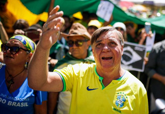 A supporter of Brazil's former president Jair Bolsonaro, on trial for his alleged role in an attempted coup, gestures during a demonstration during Independence Day, in Brasilia on September 7, 2025. Bolsonaro will test his political strength with demonstrations in the country's main cities, days before the Supreme Court deliver its verdict. The far-right leader, also a former army captain, risks up to 43 years in prison if convicted of attempting to cling to power after losing 2022 elections to his leftist rival Luiz Inacio Lula da Silva. (Photo by Arthur Menescal / AFP)