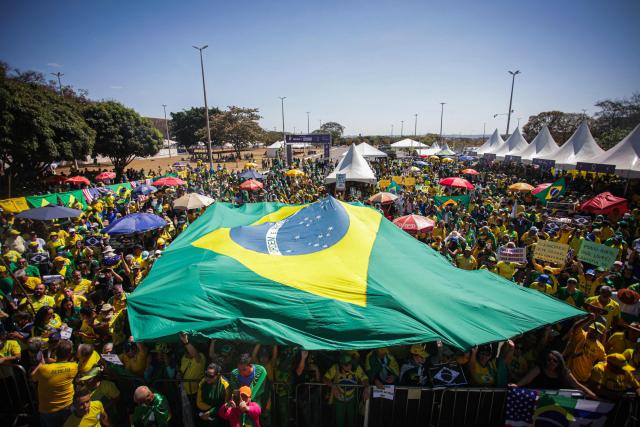 Supporters of Brazil's former president (2019-2022) Jair Bolsonaro, on trial for his alleged role in an attempted coup, take part in a demonstration during Independence Day, in Brasilia on September 7, 2025. Bolsonaro will test his political strength with demonstrations in the country's main cities, days before the Supreme Court deliver its verdict. The far-right leader, also a former army captain, risks up to 43 years in prison if convicted of attempting to cling to power after losing 2022 elections to his leftist rival Luiz Inacio Lula da Silva. (Photo by Arthur Menescal / AFP)