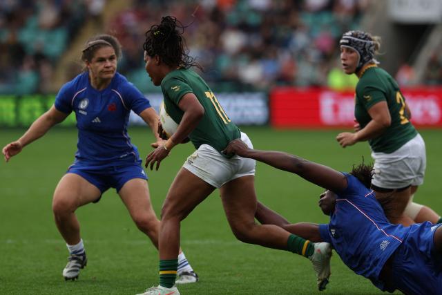 South Africa's wing Maceala Samboya (C) is tackled by France's lock Madoussou Fall (R) during the Women’s Rugby World Cup pool D match between France and South Africa at Franklin's Gardens, Northampton, central England, on September 7, 2025. (Photo by Adrian Dennis / AFP)