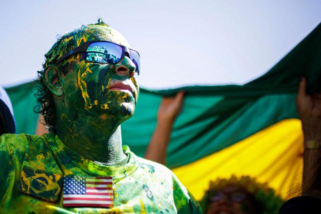 A supporter of Brazil's former president (2019-2022) Jair Bolsonaro, on trial for his alleged role in an attempted coup, takes part in a demonstration during Independence Day, in Brasilia on September 7, 2025. Bolsonaro will test his political strength with demonstrations in the country's main cities, days before the Supreme Court deliver its verdict. The far-right leader, also a former army captain, risks up to 43 years in prison if convicted of attempting to cling to power after losing 2022 elections to his leftist rival Luiz Inacio Lula da Silva. (Photo by Arthur Menescal / AFP)