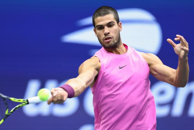 Spain's Carlos Alcaraz plays a forehand return to Italy's Jannik Sinner during the men's singles final tennis match on day fifteen of the US Open tennis tournament at the USTA Billie Jean King National Tennis Center in New York City on September 7, 2025. (Photo by CHARLY TRIBALLEAU / AFP)