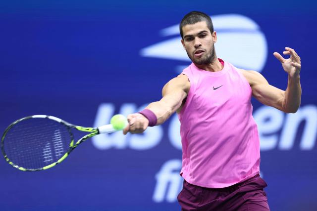 Spain's Carlos Alcaraz plays a forehand return to Italy's Jannik Sinner during the men's singles final tennis match on day fifteen of the US Open tennis tournament at the USTA Billie Jean King National Tennis Center in New York City on September 7, 2025. (Photo by CHARLY TRIBALLEAU / AFP)