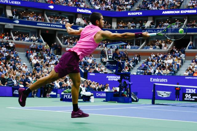 Spain's Carlos Alcaraz plays a forehand return to Italy's Jannik Sinner during the men's singles final tennis match on day fifteen of the US Open tennis tournament at the USTA Billie Jean King National Tennis Center in New York City on September 7, 2025. (Photo by KENA BETANCUR / AFP)