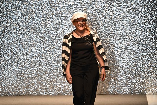 Hungarian fashion designer Katti Zoob reacts as she receives applause at the end of her fashion show on September 7, 2025, at the Millenaris cultural center in Budapest, Hungary during the Budapest Central European Fashion Week. (Photo by Attila KISBENEDEK / AFP)