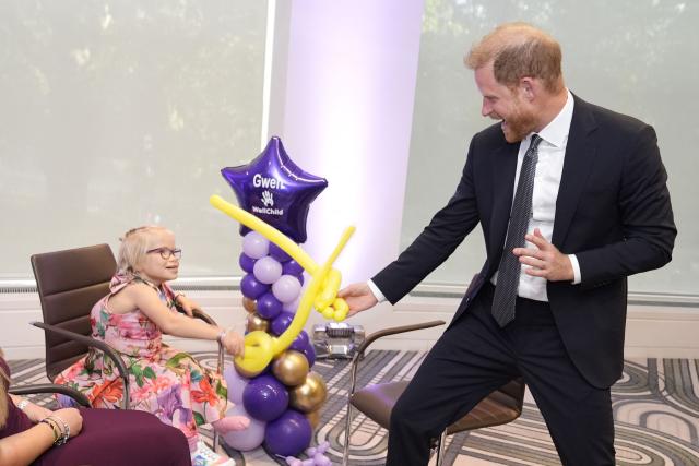 Britain's Prince Harry, Duke of Sussex (R) plays with modelling balloons with nine-year-old Gwen Foster (C), recipient of the Inspirational Child 7-11 award,speaks with six-year-old Esmee Mcglinchey (C), at the annual WellChild Awards in London on September 8, 2025. WellChild is the national charity for seriously ill children and their families. The WellChild Awards celebrate the inspiring qualities of some of the country's seriously ill young people and the dedication of those who care for and support them. (Photo by Aaron Chown / POOL / AFP)