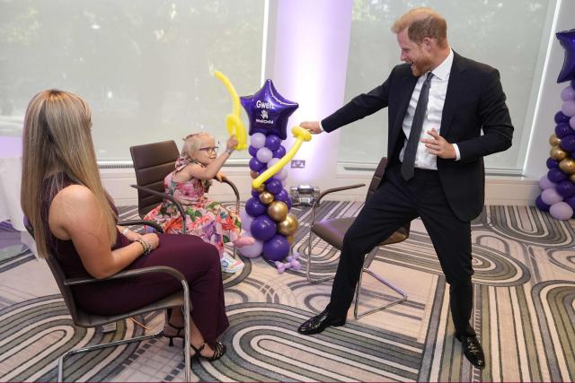 Britain's Prince Harry, Duke of Sussex (R) plays with modelling balloons with nine-year-old Gwen Foster (C), recipient of the Inspirational Child 7-11 award,speaks with six-year-old Esmee Mcglinchey (C), at the annual WellChild Awards in London on September 8, 2025. WellChild is the national charity for seriously ill children and their families. The WellChild Awards celebrate the inspiring qualities of some of the country's seriously ill young people and the dedication of those who care for and support them. (Photo by Aaron Chown / POOL / AFP)
