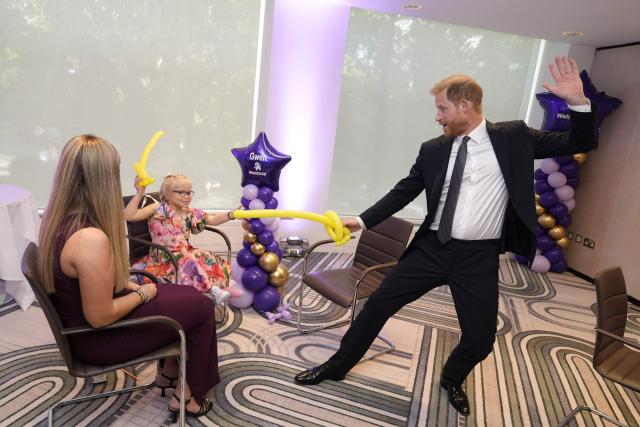 Britain's Prince Harry, Duke of Sussex (R) plays with modelling balloons with nine-year-old Gwen Foster (C), recipient of the Inspirational Child 7-11 award,speaks with six-year-old Esmee Mcglinchey (C), at the annual WellChild Awards in London on September 8, 2025. WellChild is the national charity for seriously ill children and their families. The WellChild Awards celebrate the inspiring qualities of some of the country's seriously ill young people and the dedication of those who care for and support them. (Photo by Aaron Chown / POOL / AFP)