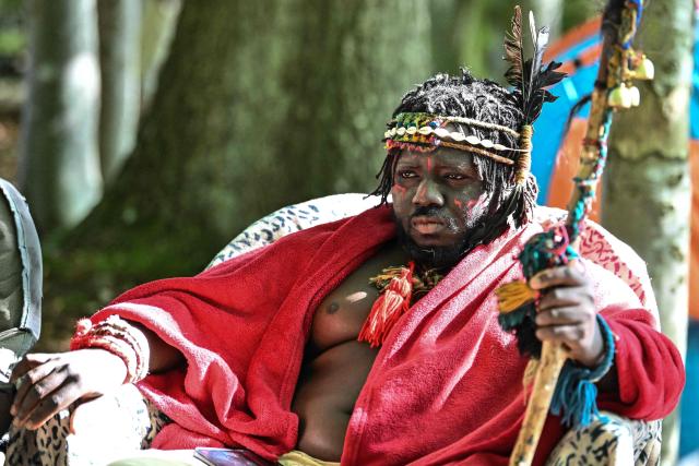 A man identifying himself as 'King Atehene' of the 'Kingdom of Kubala' poses for a photograph where they have set up camp near Jedburgh in the Scottish Borders on September 8, 2025 on what they say is their ancestral land. 'King Atehene', 'Queen Nandi' and their handmaiden 'Asnat' have set up camp near Jedburgh claiming land that they say belonged hundreds of years ago to the 'Kingdom of Kubala'. Local residents have been bringing supplies to help the three after their first camp was reportedly destroyed. The group have reportedly recieved a notice of eviction by the council. (Photo by Andy Buchanan / AFP)