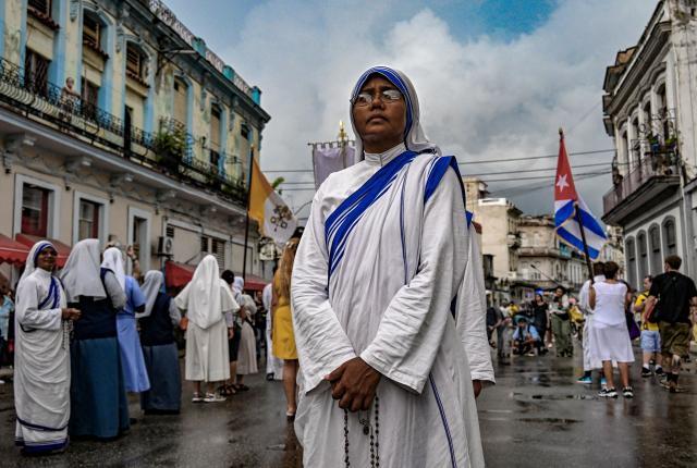 A Catholic nun and follower of the Virgin of Charity, Oxun in the Yoruba religion, attends a procession during the Oxun Day celebrations in havana on September 8, 2025. (Photo by YAMIL LAGE / AFP)
