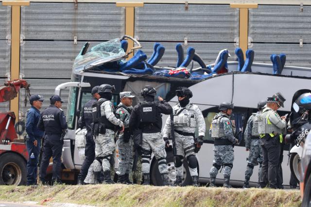 National Guard members and army soldiers arrive at the scene of an accident involving a passenger bus and a train in Atlacomulco, Mexico State, on September 8, 2025. According to the State of Mexico attorney general office, seven women and three men were killed in the accident. (Photo by Ramses VLADES / AFP)