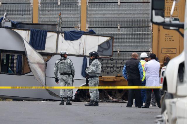 National Guard members and army soldiers arrive at the scene of an accident involving a passenger bus and a train in Atlacomulco, Mexico State, on September 8, 2025. According to the State of Mexico attorney general office, seven women and three men were killed in the accident. (Photo by Ramses VLADES / AFP)