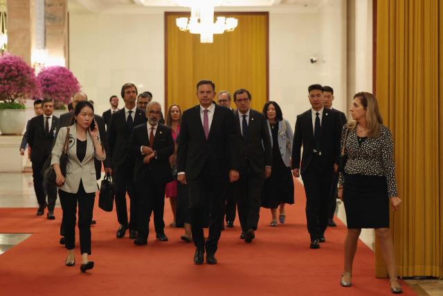 Portuguese Prime Minister Luis Montenegro (C) arrives for a meeting with Chinese President Xi Jinping at The Great Hall of the People in Beijing on September 9, 2025. (Photo by Lintao Zhang / POOL / AFP)