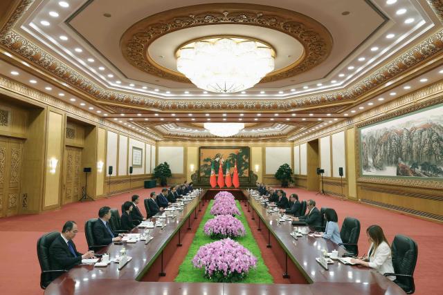 Chinese President Xi Jinping (6-L) and Portuguese Prime Minister Luis Montenegro (5-R) attend a meeting at The Great Hall of the People in Beijing on September 9, 2025. (Photo by Lintao Zhang / POOL / AFP)