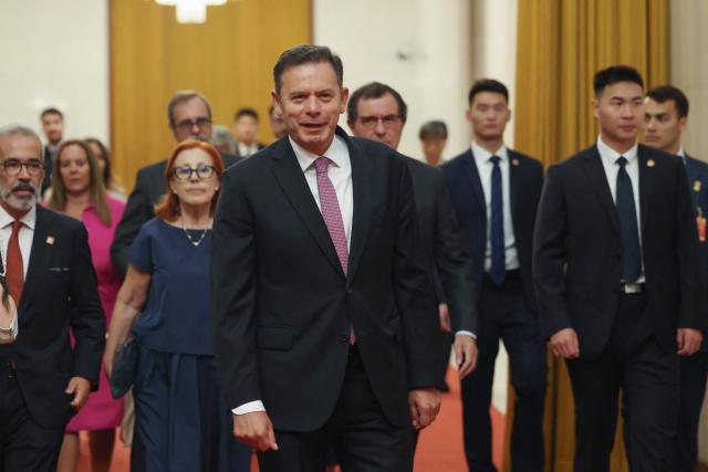 Portuguese Prime Minister Luis Montenegro (C) arrives for a meeting with Chinese President Xi Jinping at The Great Hall of the People in Beijing on September 9, 2025. (Photo by Lintao Zhang / POOL / AFP)