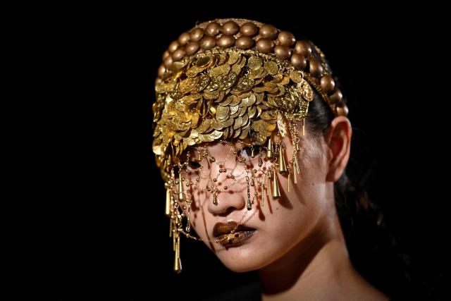 A model waits backstage before a creation from the Maggie Ma collection during the China Fashion week in Beijing on September 9, 2025. (Photo by WANG Zhao / AFP)