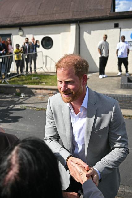 Britain's Prince Harry, Duke of Sussex chats with well-wishers after a visit to Community Recording Studio in Nottingham, central England on September 9, 2025. Set up in 1991, the Community Recording Studio, based in St Anns, teaches film and video skills as well as music, giving youngsters access to professional equipment and key industry contacts, and musicians. (Photo by Oli SCARFF / AFP)