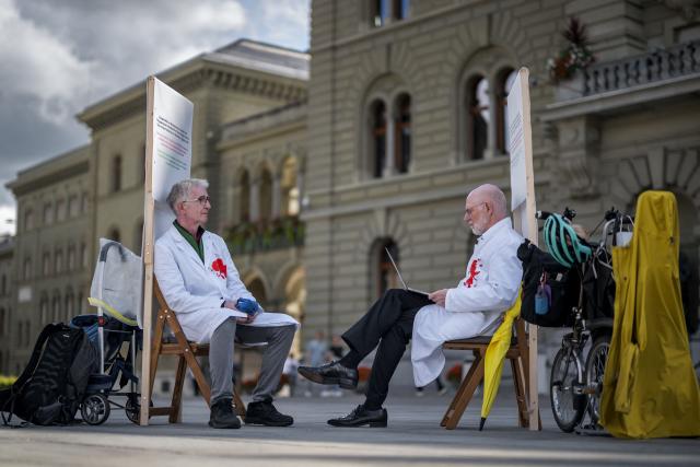 Members of Swiss Healthcare Workers Against Genocide Doctor Max Hilfiker (L) and professor Pietro Majno-Hurst stage a three-week hunger strike in front of the Federal Palace during Parliament’s autumn session, urging Switzerland to ensure respect for the Geneva Conventions in Gaza by protecting medical personnel and facilities and allowing humanitarian aid to enter, in Bern, on September 9, 2025. (Photo by Fabrice COFFRINI / AFP)