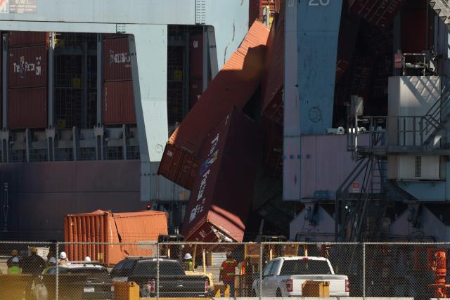 Fallen shipping containers are seen next to a vessel moored at the Port of Long Beach in Long Beach, California, on September 9, 2025. Dozens of shipping containers fell from the Portugal-registered ship called Mississippi at the major California port on September 9, 2025, halting operations as crews scrambled to limit the damage. (Photo by Patrick T. Fallon / AFP)