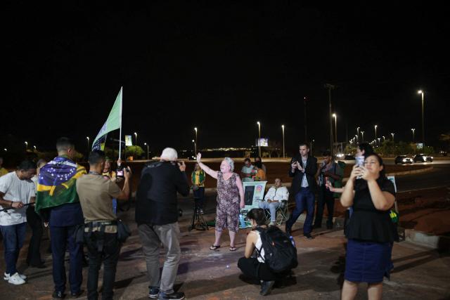 Supporters of Brazil's former President Jair Bolsonaro gather near his residence in Brasilia on September 9, 2025. Bolsonaro, 70, risks a prison term of over 40 years if found guilty of seeking to stay in power after his defeat in 2022 elections to leftist Luiz Inacio Lula da Silva. (Photo by Arthur MENESCAL / AFP)