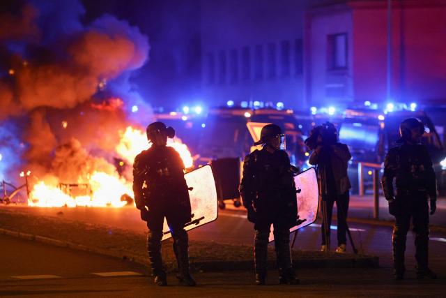 Anti-riot police officers secure a road after protesters set up a blockade towards the access to the port of Brest during a demonstration as part of the "Bloquons tout" ("Let's block everything") protest movement, in Brest, north-western France, on September 10, 2025. The broad anti-government campaign, dubbed "Bloquons tout" ("Let's block everything"), calls for a a shutdown of France on September 10 with a string of protest actions and civil disobedience around the country, while the handover of power between the new Prime Minister and his predecessor, who suffered a crushing loss in a confidence vote on September 8, is scheduled for the same day at noon. (Photo by FRED TANNEAU / AFP)
