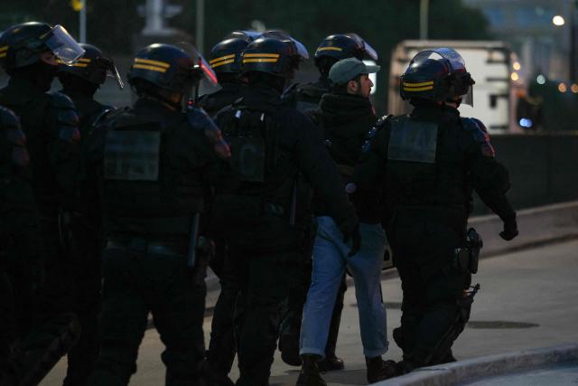 Anti-riot police officers detain a protester after demonstrators set up a blockade at on the "peripherique" ring road at porte d'Aubervilliers, during a demonstration as part of the "Bloquons tout" ("Let's block everything") protest movement, in Paris, on September 10, 2025. The broad anti-government campaign, dubbed "Bloquons tout" ("Let's block everything"), calls for a a shutdown of France on September 10 with a string of protest actions and civil disobedience around the country, while the handover of power between the new Prime Minister and his predecessor, who suffered a crushing loss in a confidence vote on September 8, is scheduled for the same day at noon. (Photo by Alain JOCARD / AFP)