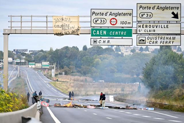 Protesters gather to block the Cadix viaduct during a demonstration as part of the "Bloquons tout" ("Let's block everything") protest movement, near Caen, north-western France, on September 10, 2025. The broad anti-government campaign, dubbed "Bloquons tout" ("Let's block everything"), calls for a a shutdown of France on September 10 with a string of protest actions and civil disobedience around the country, while the handover of power between the new Prime Minister and his predecessor, who suffered a crushing loss in a confidence vote on September 8, is scheduled for the same day at noon. (Photo by Lou BENOIST / AFP)