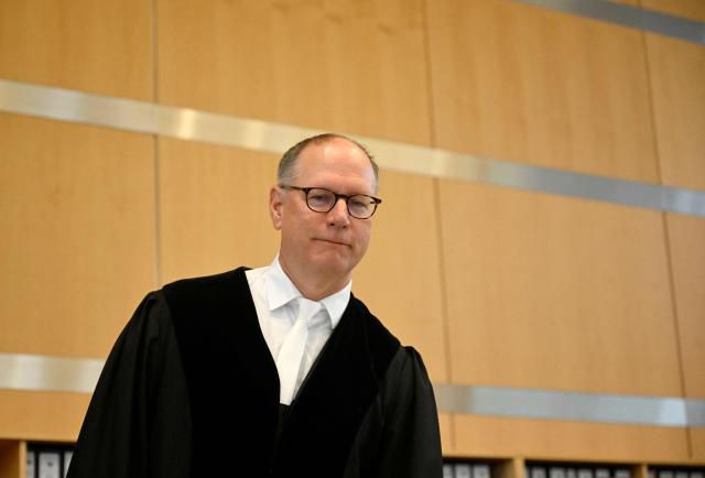 Presiding judge Winfried van der Grinten arrives for the trial against a Syrian defendant at court in Duesseldorf, western Germany, prior of the sentence at the end of the trial over a deadly knife attack that killed three people in August 2024 in Solingen, western Germany, during a summer city festival. Syrian defendant Issa Al H was sentenced to life in prison. The court in Duesseldorf said Issa Al H, who was 27 at the start of his trial in May, was a member of the Islamic State group and had acted out of "treacherous and base motives". (Photo by INA FASSBENDER / AFP)