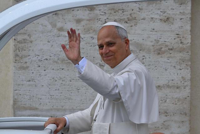 Pope Leo XIV waves to the crowd as he arrives to lead the weekly general audience at St. Peter’s square in the Vatican on September 10, 2025. (Photo by Andreas SOLARO / AFP)