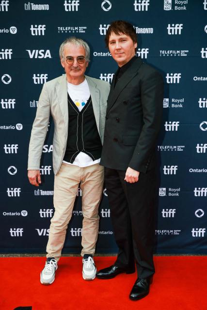 French filmmaker Olivier Assayas (L) and US actor Paul Dano attend the premiere of "The Wizard of the Kremlin" at Princess of Wales Theatre, during the Toronto International Film Festival (TIFF) in Toronto, Ontario, on September 10, 2025. (Photo by Cole BURSTON / AFP)