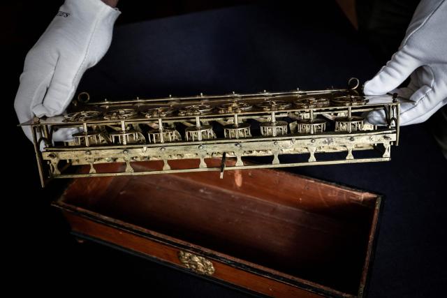 This photograph shows La Pascaline, first mechanical calculating machine invented by French polymathe Blaise Pascal displayed at the Christie's auction house in Paris, on September 11, 2025. This model, the only one known to have been used for calculating land surveys, is expected to change hands for between Ђ2 millions and Ђ3 millions. (Photo by STEPHANE DE SAKUTIN / AFP)