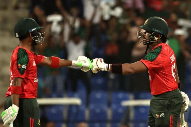 Bangladesh's Parvez Hossain Emon (R) and Tanzid Hasan bump their fists during the Asia Cup 2025 Twenty20 international cricket match between Bangladesh and Hong Kong at the Sheikh Zayed Cricket Stadium in Abu Dhabi on September 11, 2025. (Photo by Fadel SENNA / AFP)