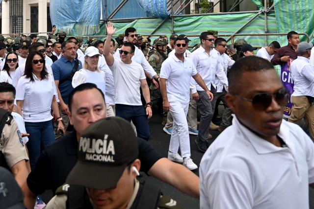 Ecuador's President Daniel Noboa (C) waves as he leads a march for peace and justice in Guayaquil, Ecuador, on September 11, 2025. (Photo by MARCOS PIN / AFP)