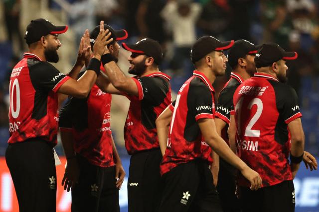 Hong Kong's players celebrate after the dismissal of Bangladesh's Parvez Hossain Emon during the Asia Cup 2025 Twenty20 international cricket match between Bangladesh and Hong Kong at the Sheikh Zayed Cricket Stadium in Abu Dhabi on September 11, 2025. (Photo by Fadel SENNA / AFP)