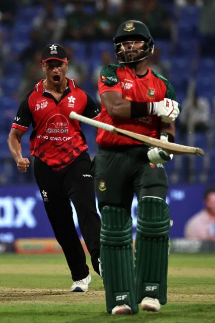 Bangladesh's Parvez Hossain Emon walks back to the pavilion after his dismissal during the Asia Cup 2025 Twenty20 international cricket match between Bangladesh and Hong Kong at the Sheikh Zayed Cricket Stadium in Abu Dhabi on September 11, 2025. (Photo by Fadel SENNA / AFP)
