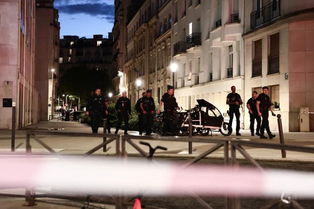 French police officers patrol by the Rue d'Eble in the 7th district of Paris as they look for a fugitive following an attack with a bladed weapon earlier in the day in Paris, on September 11, 2025. A man was wounded on September 11, 2025 with a bladed weapon, possibly a cleaver, near Les Invalides, in Paris's 7th arrondissement, by another man who fled the scene, according to the Paris police and the Paris public prosecutor's office. (Photo by Thibaud MORITZ / AFP)