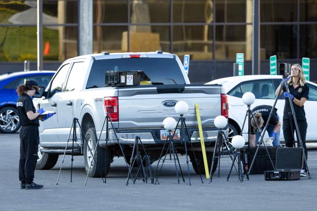 Agents with FBI forensic team prepare their gear while investigating the secene where youth activist and influencer Charlie Kirk was shot during a public event at Utah Valley University in Orem, Utah, on September 11, 2025. The gunman who shot dead US right-wing youth leader Charlie Kirk in a targeted killing remained at large Thursday but authorities said they have video images of the suspect and have recovered a "high-powered" rifle. Kirk, a 31-year-old superstar on the Republican right who was credited with helping Donald Trump return to the presidency last year, was shot while addressing a large crowd at Utah Valley University on Wednesday. (Photo by Melissa MAJCHRZAK / AFP)