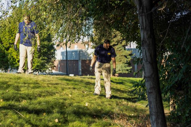 Law enforcement officials, including members of an FBI forensics team, investigate near the crime scene where political activist Charlie Kirk was shot and killed at Utah Valley University in Orem, Utah, on September 11, 2025. The gunman who shot dead US right-wing youth leader Charlie Kirk in a targeted killing remained at large Thursday but authorities said they have video images of the suspect and have recovered a "high-powered" rifle. Kirk, a 31-year-old superstar on the Republican right who was credited with helping Donald Trump return to the presidency last year, was shot while addressing a large crowd at Utah Valley University on Wednesday. (Photo by Melissa MAJCHRZAK / AFP)