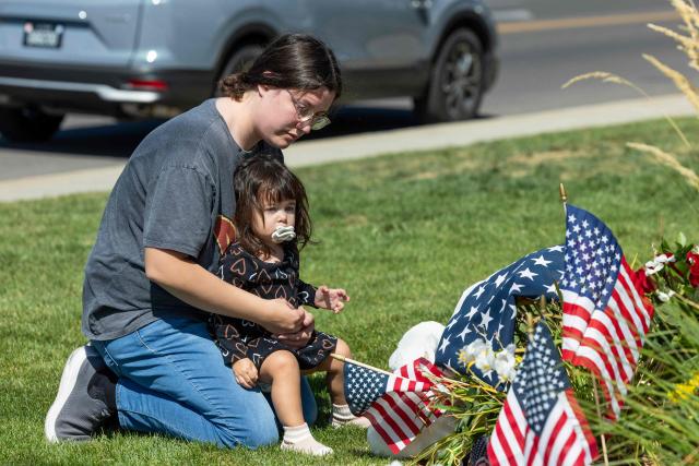 A woman pays tribute to Charles Kirk at a memorial set up outside of Timpanogos Regional Hospital in Orem, Utah, on September 11, 2025. The gunman who shot dead US right-wing youth leader Charlie Kirk in a targeted killing remained at large Thursday but authorities said they have video images of the suspect and have recovered a "high-powered" rifle. Kirk, a 31-year-old superstar on the Republican right who was credited with helping Donald Trump return to the presidency last year, was shot while addressing a large crowd at Utah Valley University on Wednesday. (Photo by Melissa MAJCHRZAK / AFP)