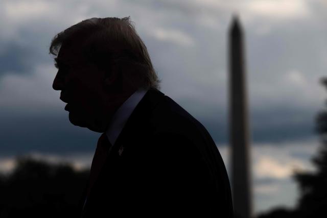 US President Donald Trump is silhouetted as he speaks to the press before boarding Marine One prior to departing from the South Lawn of the White House in Washington, DC, on September 11, 2025. Trump is going to New York to attend a Yankees baseball game. (Photo by SAUL LOEB / AFP)