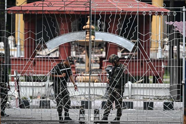 Army personnel stand guard outside the President House during a curfew imposed to restore law and order in Kathmandu on September 12, 2025. The army has imposed a curfew in the Himalayan nation of 30 million people, with soldiers patrolling the largely quiet streets after the worst violence in two decades. (Photo by Pedro Pardo / AFP)