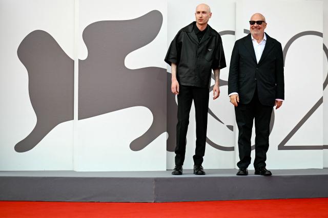 British composer Daniel Blumberg and Italian director Gianfranco Rosi (R) attend the red carpet for the movie "Sotto le Nuvole" (Below the Clouds) presented in competition at the 82nd International Venice Film Festival, at Venice Lido on August 30, 2025. (Photo by Tiziana FABI / AFP)