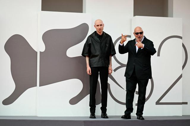 British composer Daniel Blumberg and Italian director Gianfranco Rosi attend the red carpet for the movie "Sotto le Nuvole" (Below the Clouds) presented in competition at the 82nd International Venice Film Festival, at Venice Lido on August 30, 2025. (Photo by Tiziana FABI / AFP)