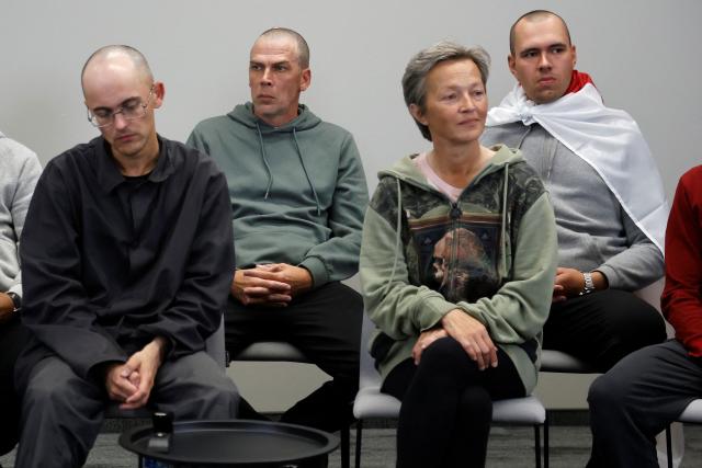 Belsat journalist Iryna Slaunikava (front E), cameraman Pavel Padabed (back L) and others look on during a press conference with exiled Belarusian opposition leader Tikhanovskaya and other freed political prisoners in Vilnius on September 12, 2025, a day after Belarus freed 52 political prisoners in a release mediated by the United States. Among those released are an EU staff member, journalists, and dissidents. Many were detained during a brutal crackdown and later prosecuted on what rights groups denounced as politically motivated charges. (Photo by Petras Malukas / AFP)